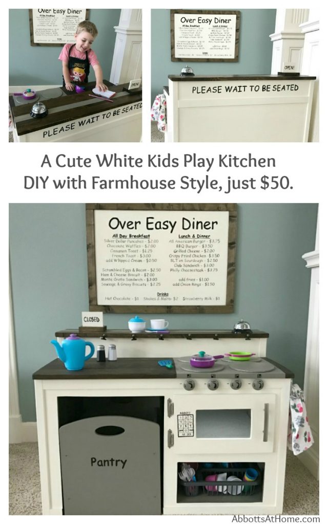 A super cute white kids play kitchen DIY with Farmhouse Style and restaurant menu board. I built this for about $50 and it's so cute. Kids love the food pantry, diner menu, dinner bell, motion-activated microwave light, open and closed sign.
