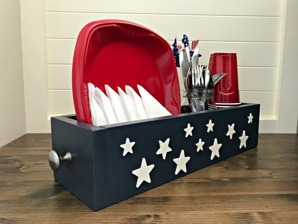 Make an Easy Patriotic Table DIY Utensil Caddy, just $7. Give those summer backyard BBQ's and beach picnics a patriotic touch with this American themed utensil caddy basket. Makes great home decor, gifts, craft party projects, centerpieces, and more. Can be sold at craft fairs and online too.