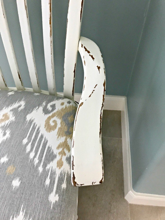 A close up of paint distressing on chair arm. Get the DIY Steps and my secret to How to paint and distress furniture perfectly, every time. #Distressing #FurnitureMakeover #ChippyFurniture