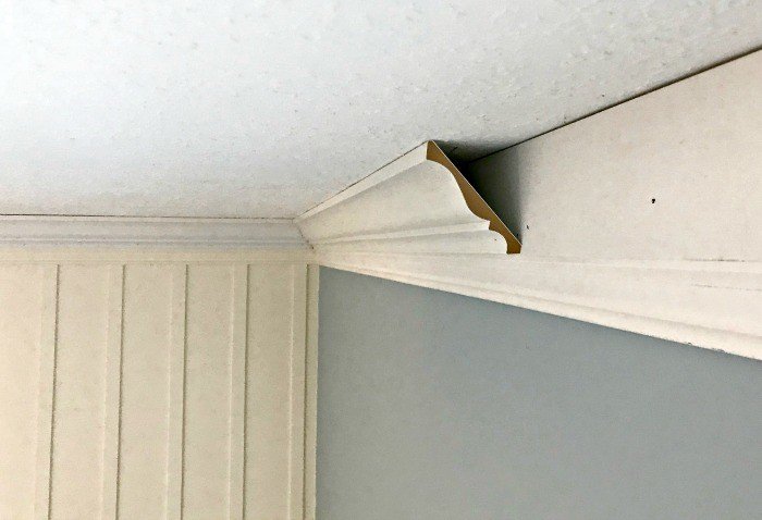 Crown Molding Installation above board and batten. DIY Board and Batten Wainscoting with lattice. Wainscoting ideas with classic style and Farmhouse woodworking charm.