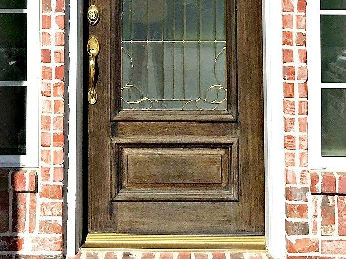 Quick & easy DIY for how to restain a door without stripping off the old wood finish. Just give the door a quick cleaning and light sanding. You can leave the old finish in place. This front door makeover works over old stain! #stain #frontdoor