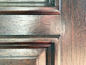 Quick & easy DIY for how to restain a door without stripping off the old wood finish. Just give the door a quick cleaning and light sanding. You can leave the old finish in place. This front door makeover works over old stain! #stain #frontdoor