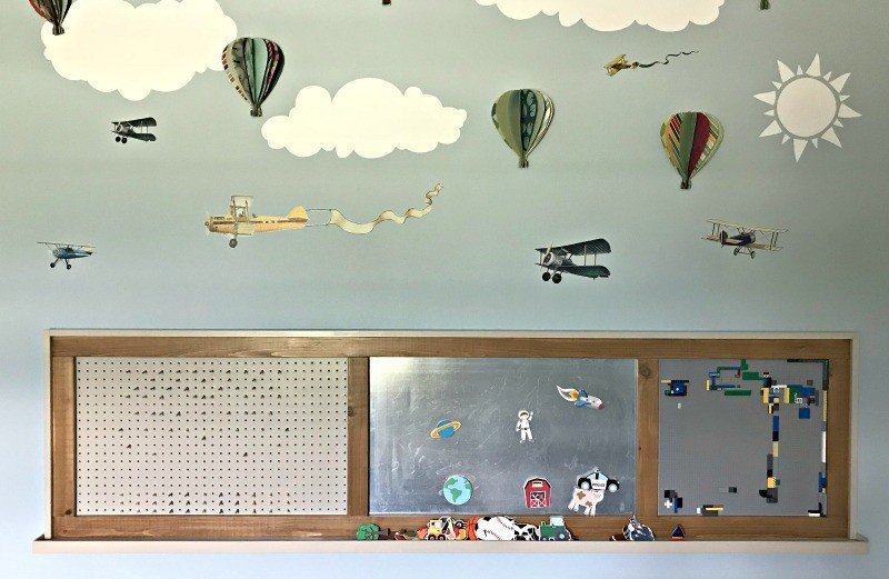 The full board with the planes, balloons, and clouds I added. Build a fun DIY Modern Farmhouse Kids Activity Wall Board. With 20 Ideas for board options that work for kids, teens, and adults. #ModernFarmhouse #KidsFurniture #DIYKids #AbbottsAtHome