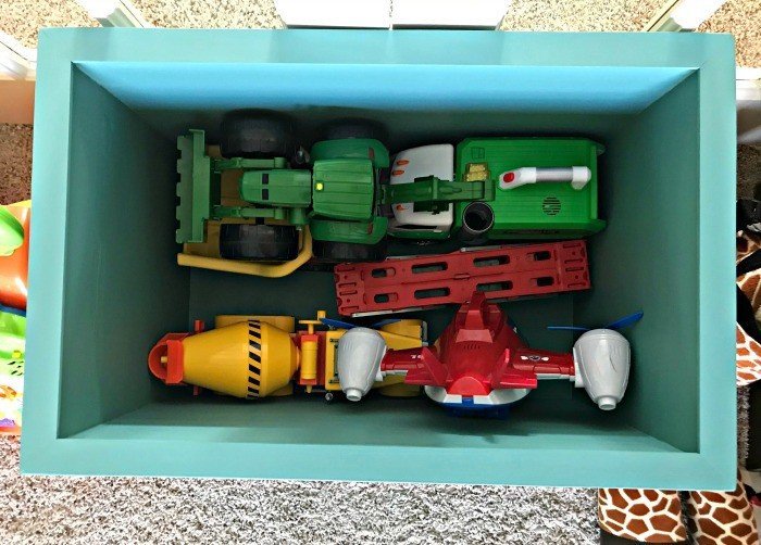 6 of those large kids toys in the bottom of the crate and there's still tons of room. Build a Modern Farmhouse DIY Wooden Toy Storage Box for all of those kids toys. Makes a beautiful throw pillow and blanket box in a Living Room or catch all storage box for teens too! #AbbottsAtHome #StorageBox #ToyBox #DIYStorage