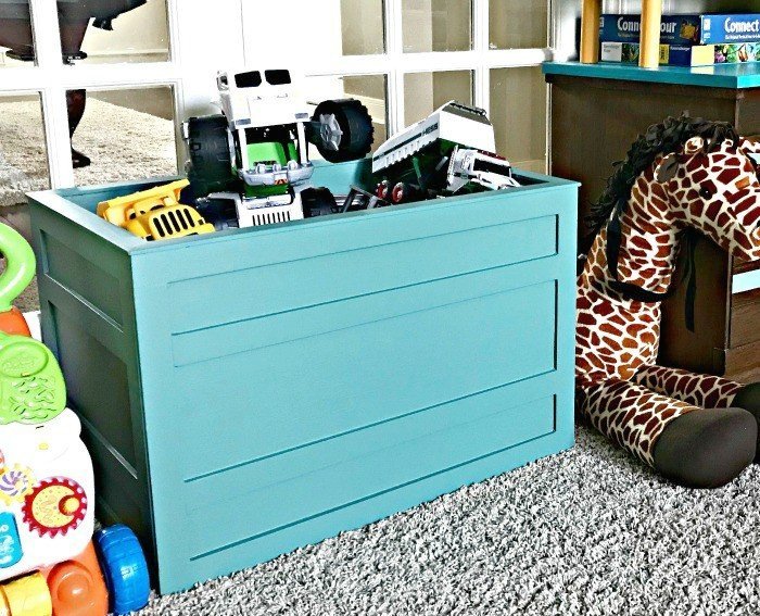 Teal Farmhouse Fun Kids DIY Storage Box. Build a Modern Farmhouse DIY Wooden Toy Storage Crate or Box for all of those kids toys cluttering up your house. Makes a beautiful throw pillow and blanket box in a Living Room or catch all storage box for teens too! #AbbottsAtHome #StorageBox #ToyBox #DIYStorage