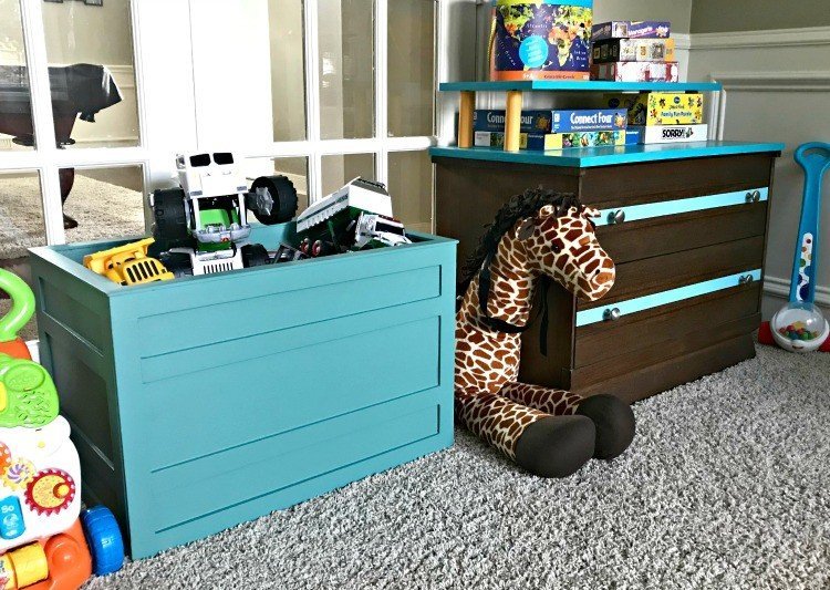 Kids playroom toy storage in a open DIY teal crate and a low dresser. Build a Modern Farmhouse DIY Wooden Toy Storage Crate or Box for all of those kids toys cluttering up your house. Makes a beautiful throw pillow and blanket box in a Living Room or catch all storage box for teens too! #AbbottsAtHome #StorageBox #ToyBox #DIYStorage