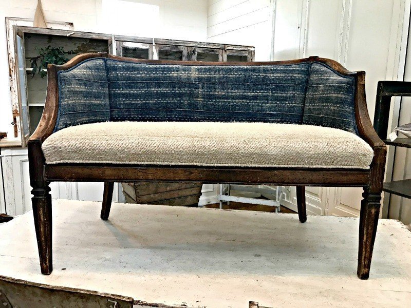 Small love seat with mixed fabric patterns, in blues and creams. The Spring and Fall Round Top Texas Antiques and Flea Markets are great! BUT you can find Fun, Art & Furniture Shopping in Round Top, Texas year round, guys! Check out photos from the shops in town. #RoundTop #TexasTravel #AbbottsAtHome