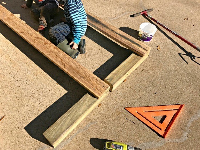 Start by screwing the frame together. Build this DIY Rustic Farmhouse Outdoor Bench with just a drill and a saw. This is a great 2x4 bench project. #AbbottsAtHome #DIYBench #DIYFurniture #2x4bench