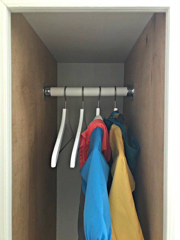 You'll love this DIY Tall Cabinet Makeover into Coat and Shoe Storage. Convert any cabinets into pretty open cabinet storage with these tips and steps that'll make sure your open cabinets look like custom built-ins. #AbbottsAtHome #OpenCabinets #OpenShelves #MudroomIdeas #CabinetMakeover