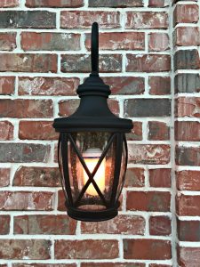 We love this beautiful Allen + Roth Rubbed Bronze and Seeded Glass Front Porch Light. It's completely transformed our porch. Instant curb appeal, guys! #AbbottsAtHome #CurbAppealIdeas #Lighting #PorchIdeas