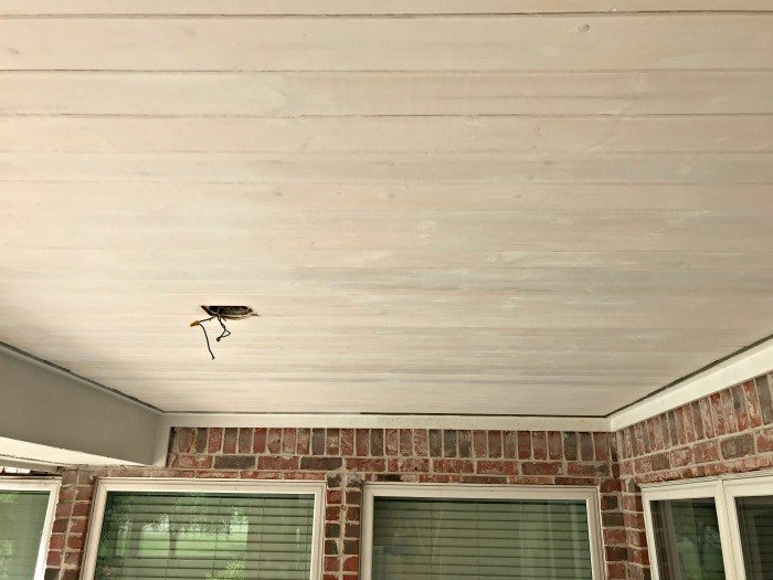 A DIY Pine Tongue and Groove Ceiling Tutorial that will turn your porch into that beautiful, charming spot you've always wanted. For most porches, you can have these wood planks installed in a weekend, guys! #AbbottsAtHome #PlankCeiling #PorchCeiling #TongueAndGroove