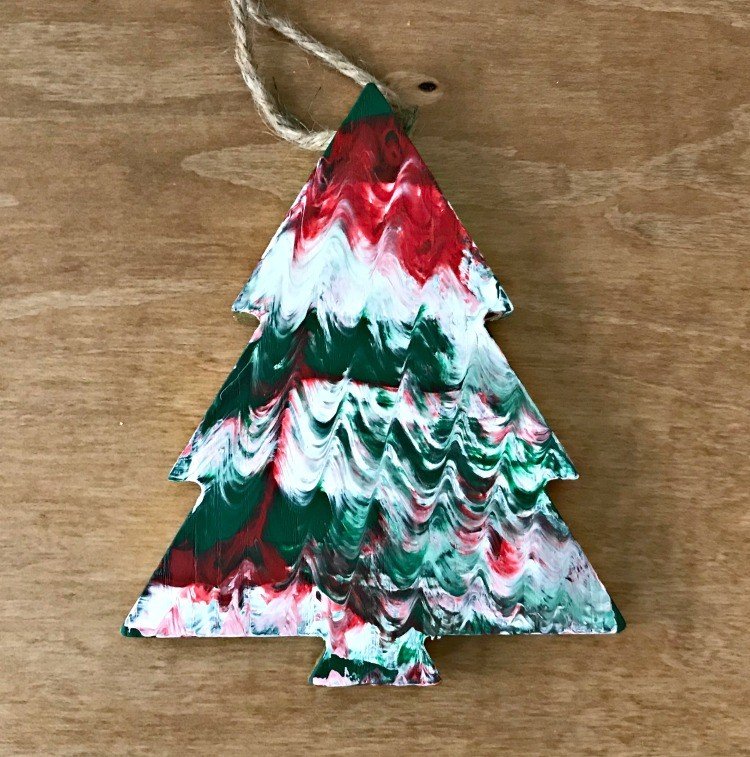 Paint Smear Ornament. Need some new ideas for this years Christmas craft? I've got 12 fun and easy handmade Christmas Ornament Ideas for you! Make 3D scrapbook paper trees, pom pom trees, star string art, unicorn stars, and more. #AbbottsAtHome #Handmade #ChristmasCrafts #ChristmasIdeas #ChristmasOrnaments