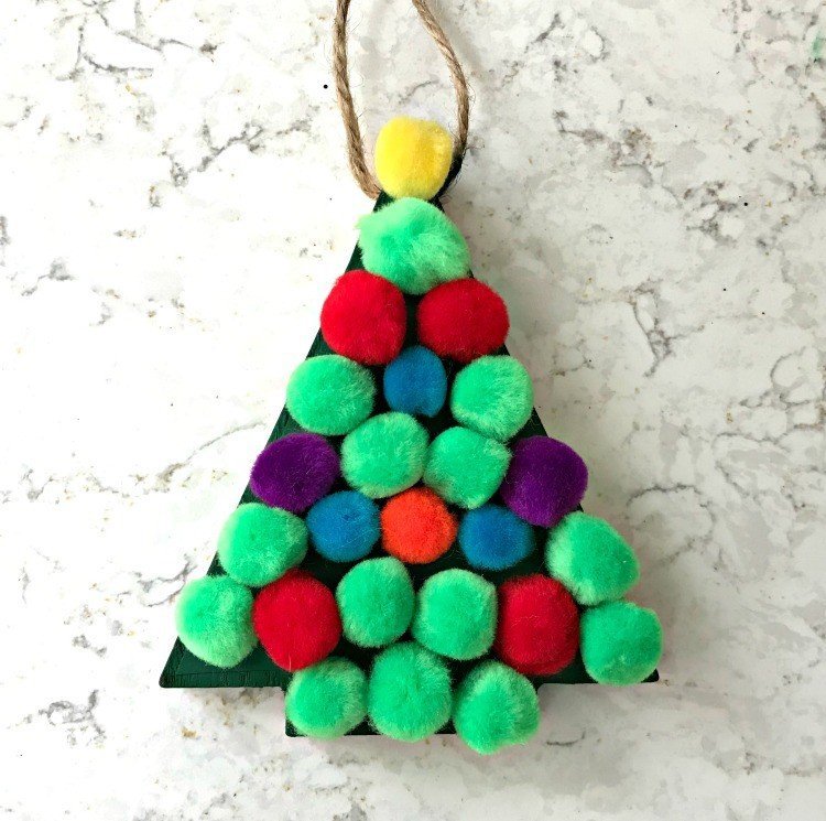Pom Pom Tree Ornament. Need some new ideas for this years Christmas craft? I've got 12 fun and easy handmade Christmas Ornament Ideas for you! Make 3D scrapbook paper trees, pom pom trees, star string art, unicorn stars, and more. #AbbottsAtHome #Handmade #ChristmasCrafts #ChristmasIdeas #ChristmasOrnaments