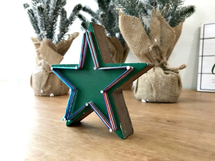 Star String Art. Need some new ideas for this years Christmas craft? I've got 12 fun and easy handmade Christmas Ornament Ideas for you! Make 3D scrapbook paper trees, pom pom trees, star string art, unicorn stars, and more. #AbbottsAtHome #Handmade #ChristmasCrafts #ChristmasIdeas #ChristmasOrnaments