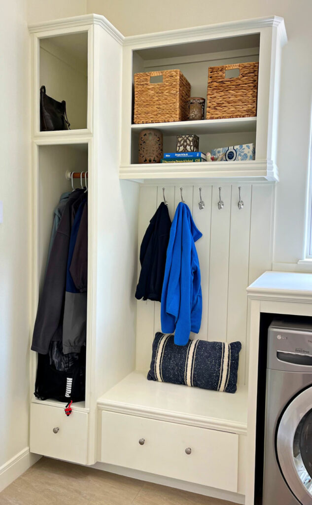Image of a white mudroom laundry room combo with a DIY convert cabinets into bench seating and storage.
