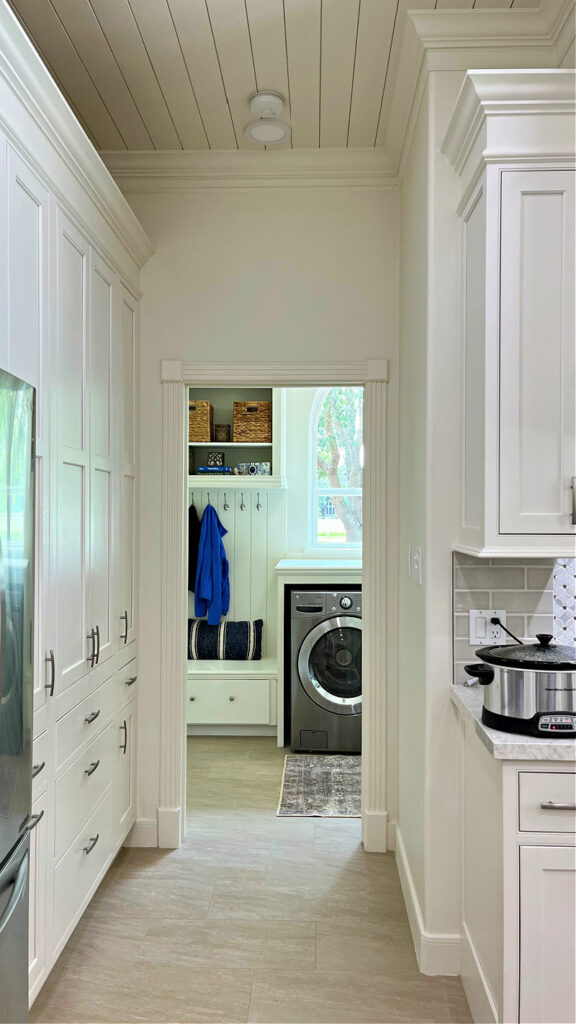 Large white kitchen and laundry room in a traditional home.