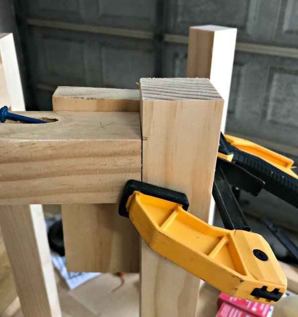 Using clamps and scrap wood to hold 22x2 Pine pieces in the right spot when gluing and screwing together.