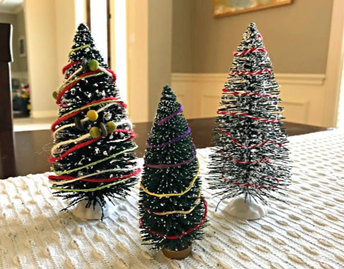 Wrap Bottle Brush trees with embroidery floss or Christmas present wrapping twine to make them look more Christmas-y