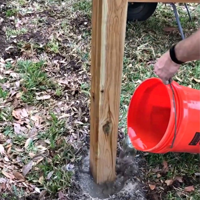 Here's how to set wooden fence posts in concrete - with written steps and a quick video to show you how to build or DIY your own Three Rail Fence or other horizontal fence ideas.