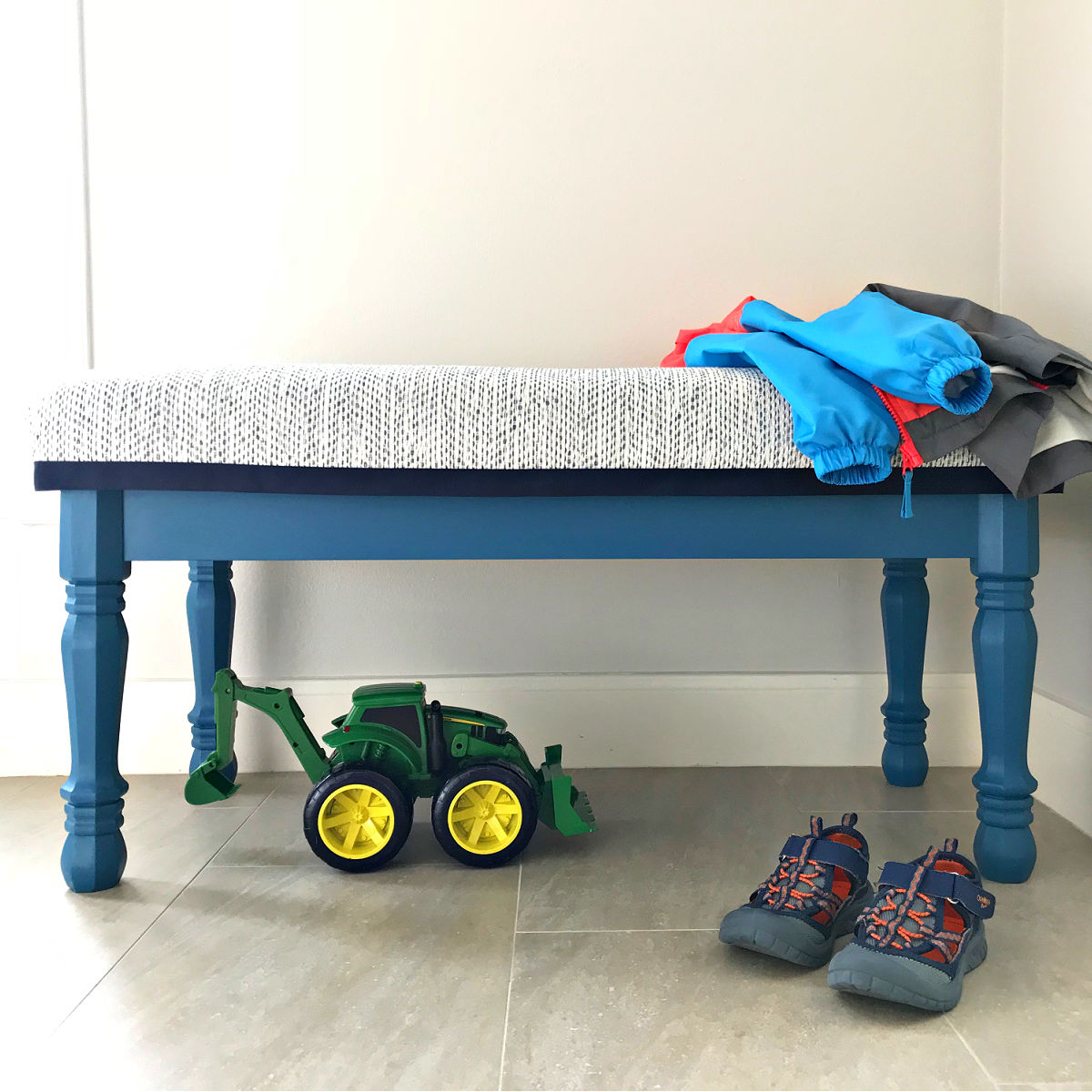 I LOVE this easy DIY Upholstered Entryway Bench Build Plan made with cheap turned legs. It's a beautiful bench you can paint or stain. Steps to build with a hard top or upholstered top.